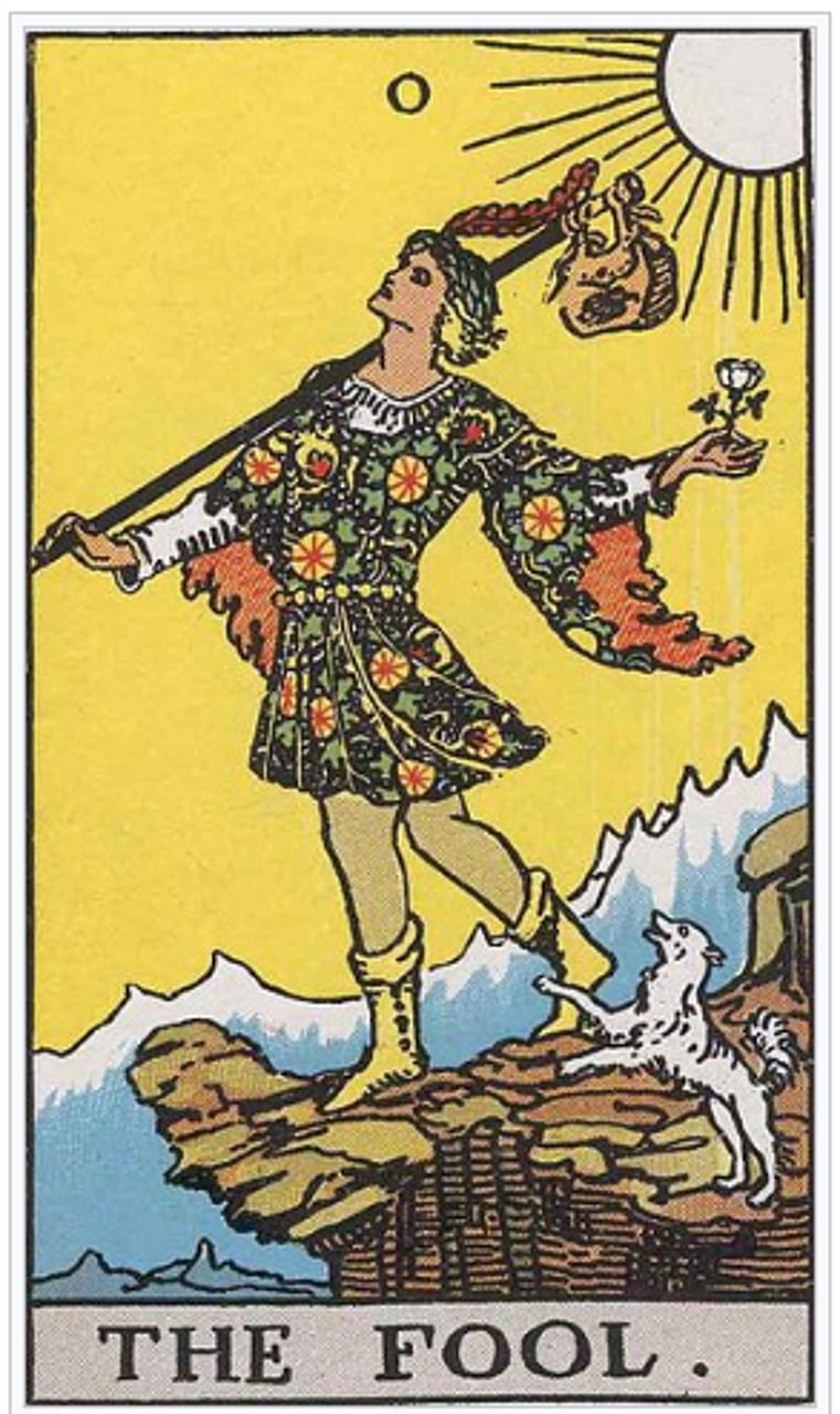 The Fool tarot card from the Rider Waite tarot deck. aa person standing on the edge of a cliff getting ready to walk off it onto a new journey as he holds a white rose. A little white dog is up on it's back legs taking the journey with the fool.