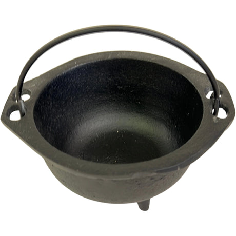 Small black cast iron cauldron with a handle and three legs.