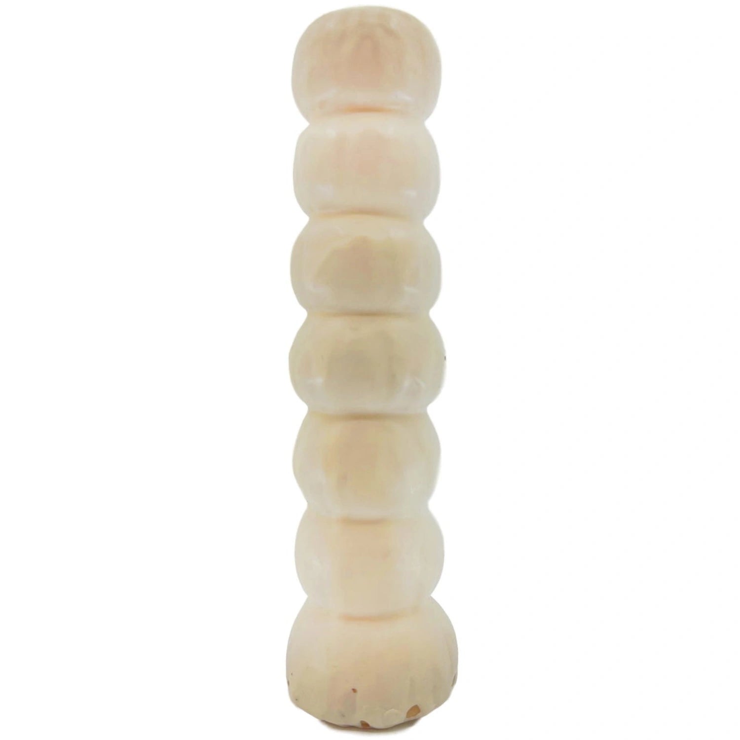 White, ribbed candle with a flared base.