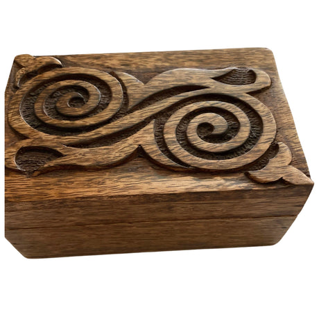 Wooden box with intricate spiral carvings.