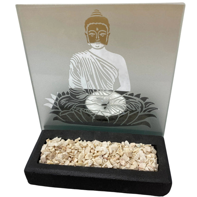 Glass candle holder featuring a Buddha figure sitting on a lotus flower. The holder has a black base and white stones.