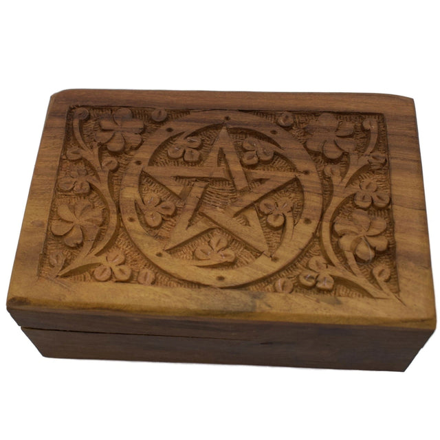 Wooden box with carved pentagram and floral motifs.