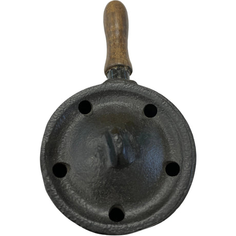 Cast iron incense burner with a wooden handle and holes for air flow.