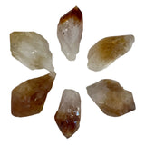 A cluster of small, pointed citrine crystals with a translucent yellow color.
