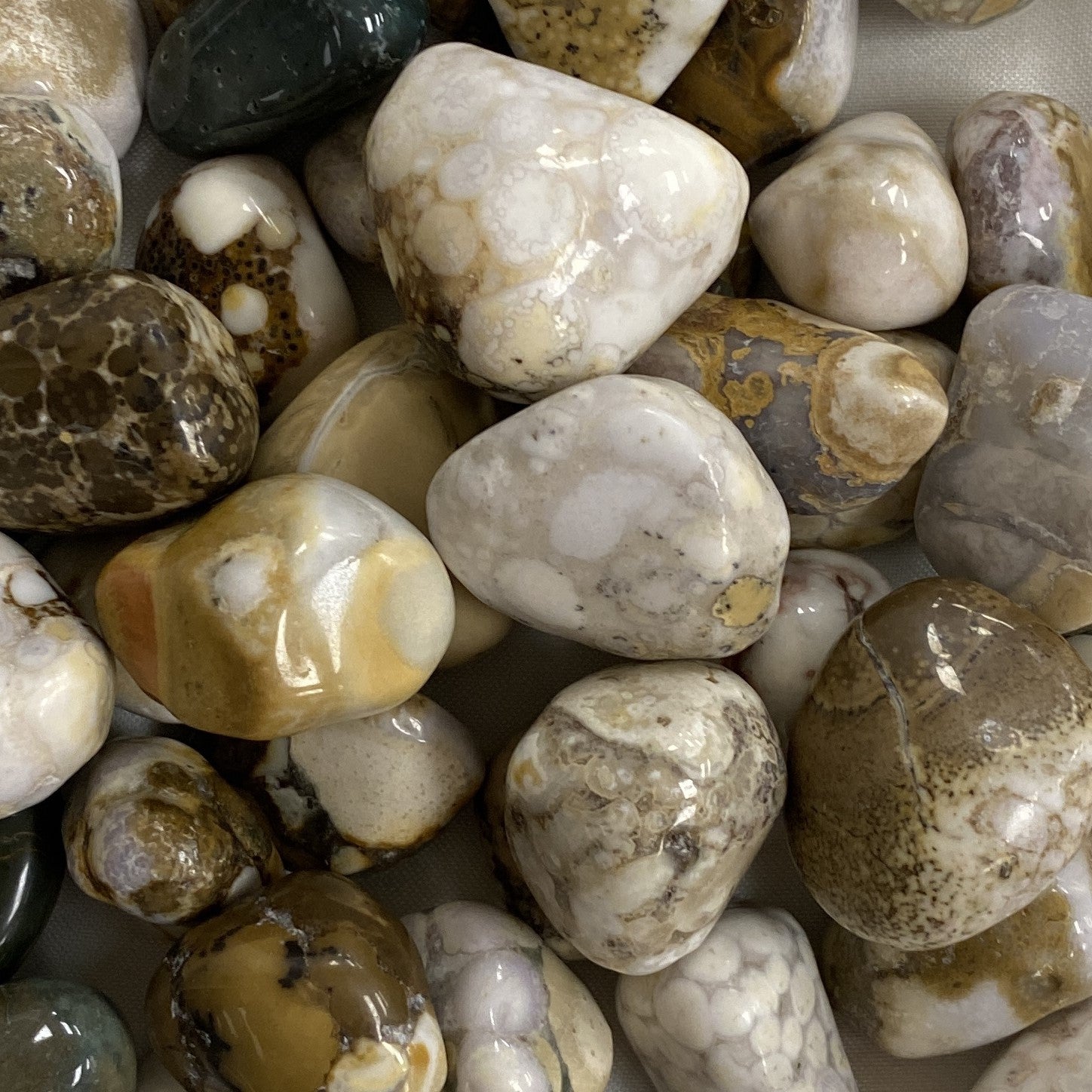 Close-up of several polished cobra jasper stone, a symbol of the guardian spirit, encouraging courage, self-discovery, and overcoming challenges.