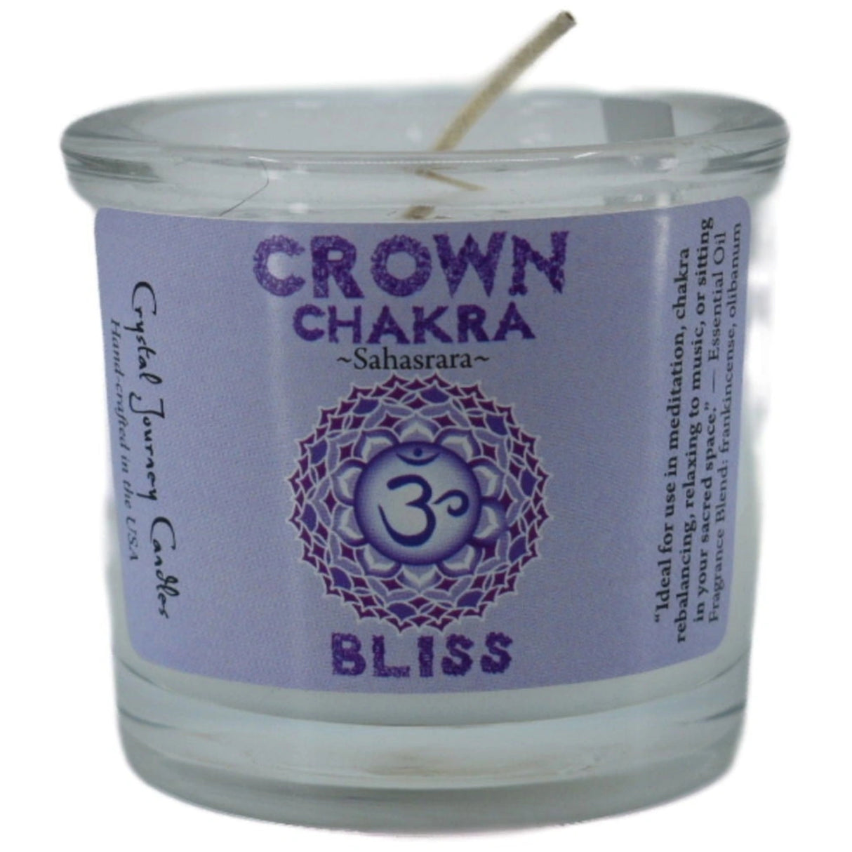 White votive candle with the words "CROWN CHAKRA," "SAHASRARA," and "BLISS" printed on it. The candle is surrounded by a purple label with additional information about its use for meditation and chakra balancing.