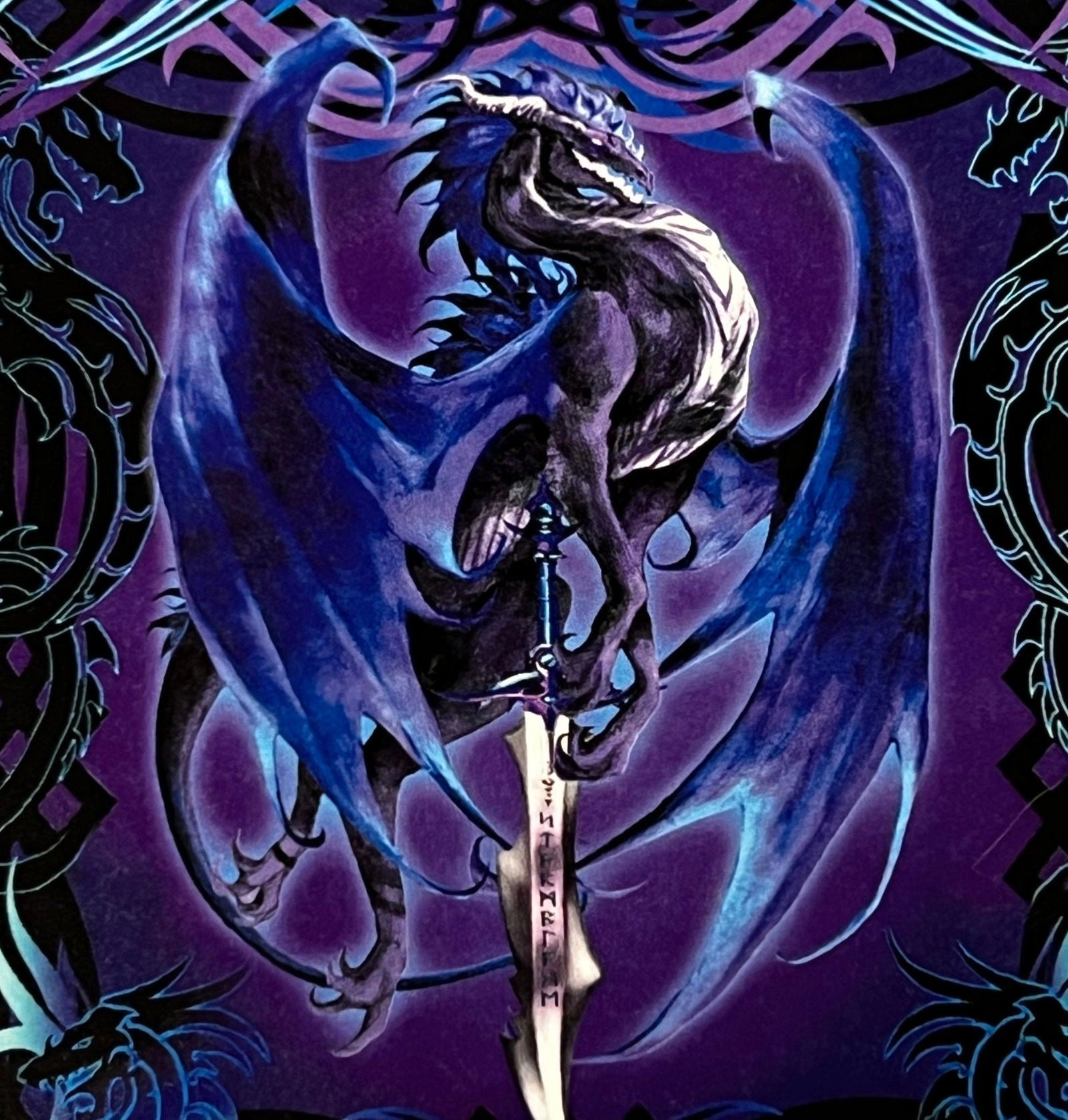 Dragon Sword magnet with a blue dragon holding a sword, surrounded by dragon-like patterns.