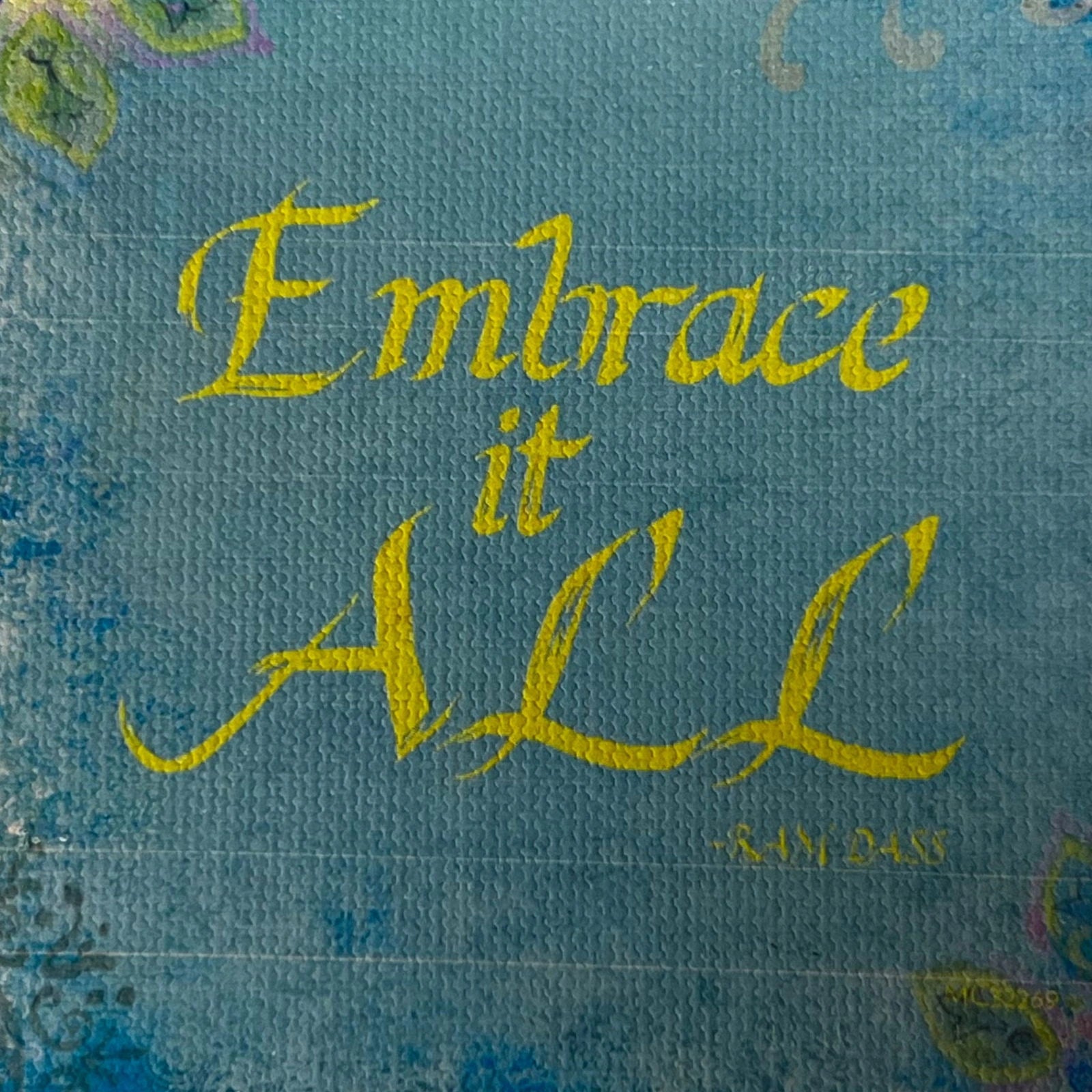 Embrace It All canvas magnet with inspirational quote in yellow calligraphy.