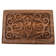 Wooden box with carved goddess figure and swirling patterns.