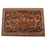 Wooden box with carved goddess figure and swirling patterns.