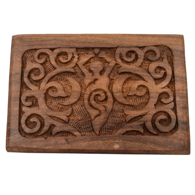 Wooden box with carved goddess figure and swirling patterns.