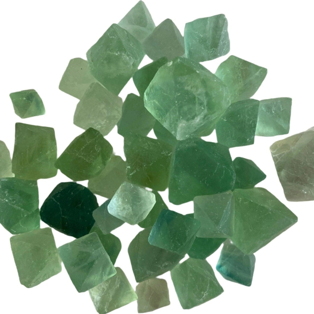 Tumbled Green Fluorite cubes with a smooth, polished finish and a variety of green hues, ranging from pale green to deep emerald green.