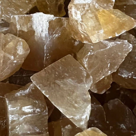 Raw Honey Calcite stones with a natural, rough finish and a translucent honey-yellow color.