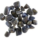 Tumbled Iolite stones with a smooth, polished finish and a variety of blue hues, ranging from deep violet to lighter blue-gray.