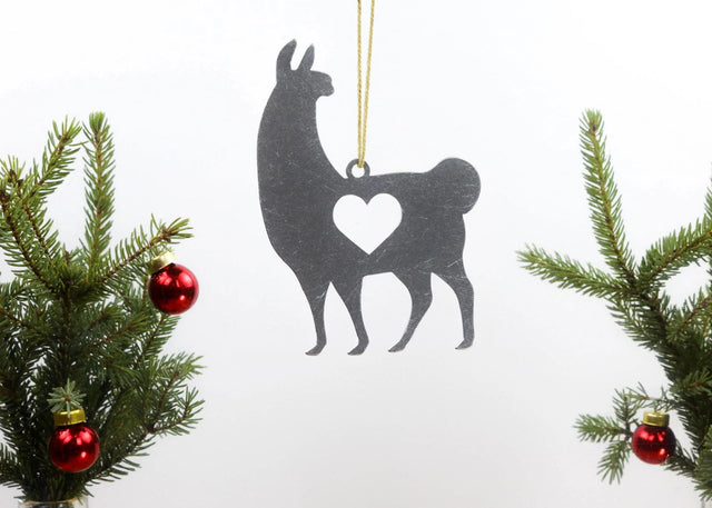 Llama metal ornament with heart cutout, hanging from a Christmas tree branch.