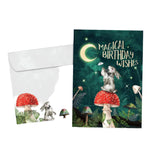 Magical wishes birthday  green card with image of rabbit sitting on a red mushroom 