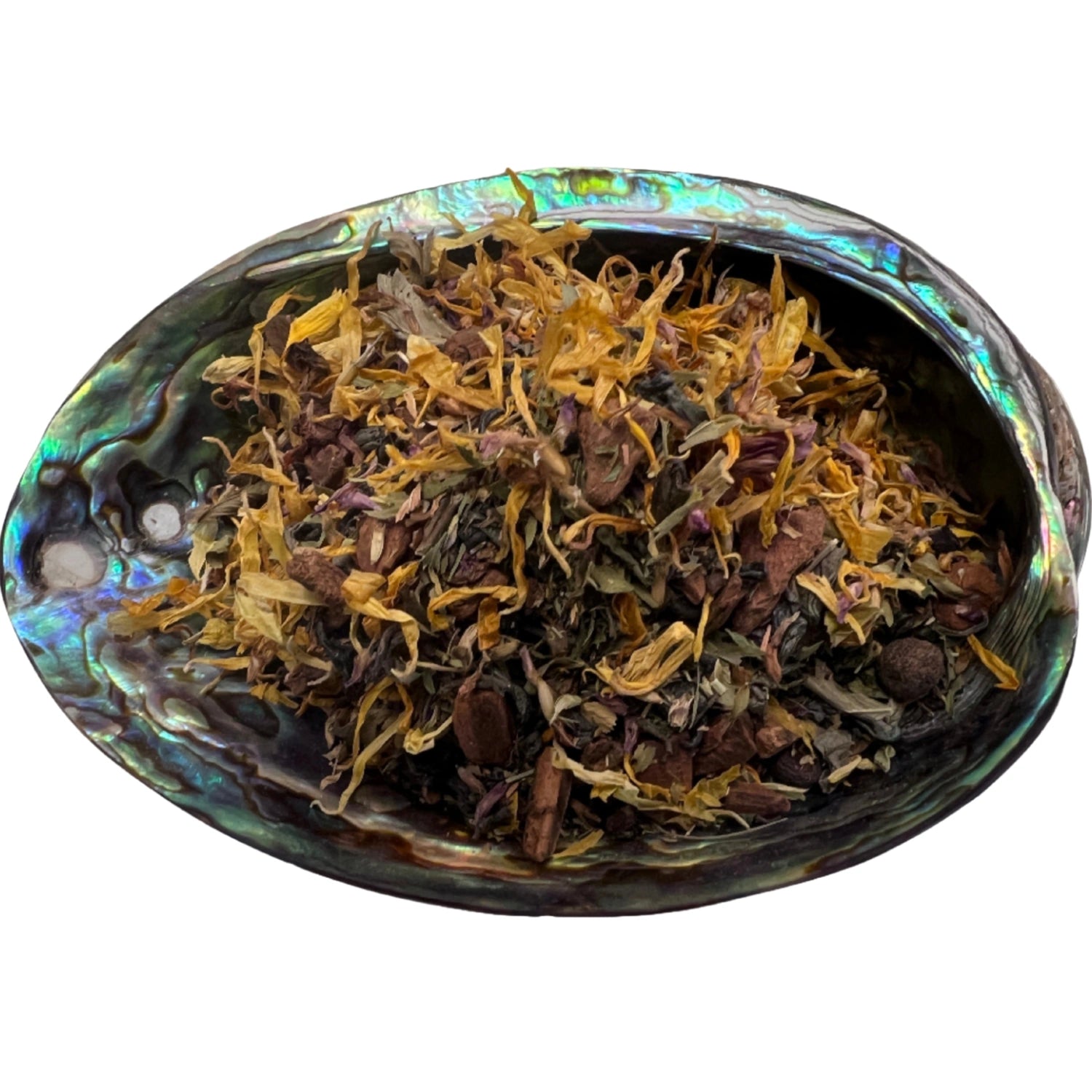 Dried Manifestation Blend Tea herbs in an abalone shell.