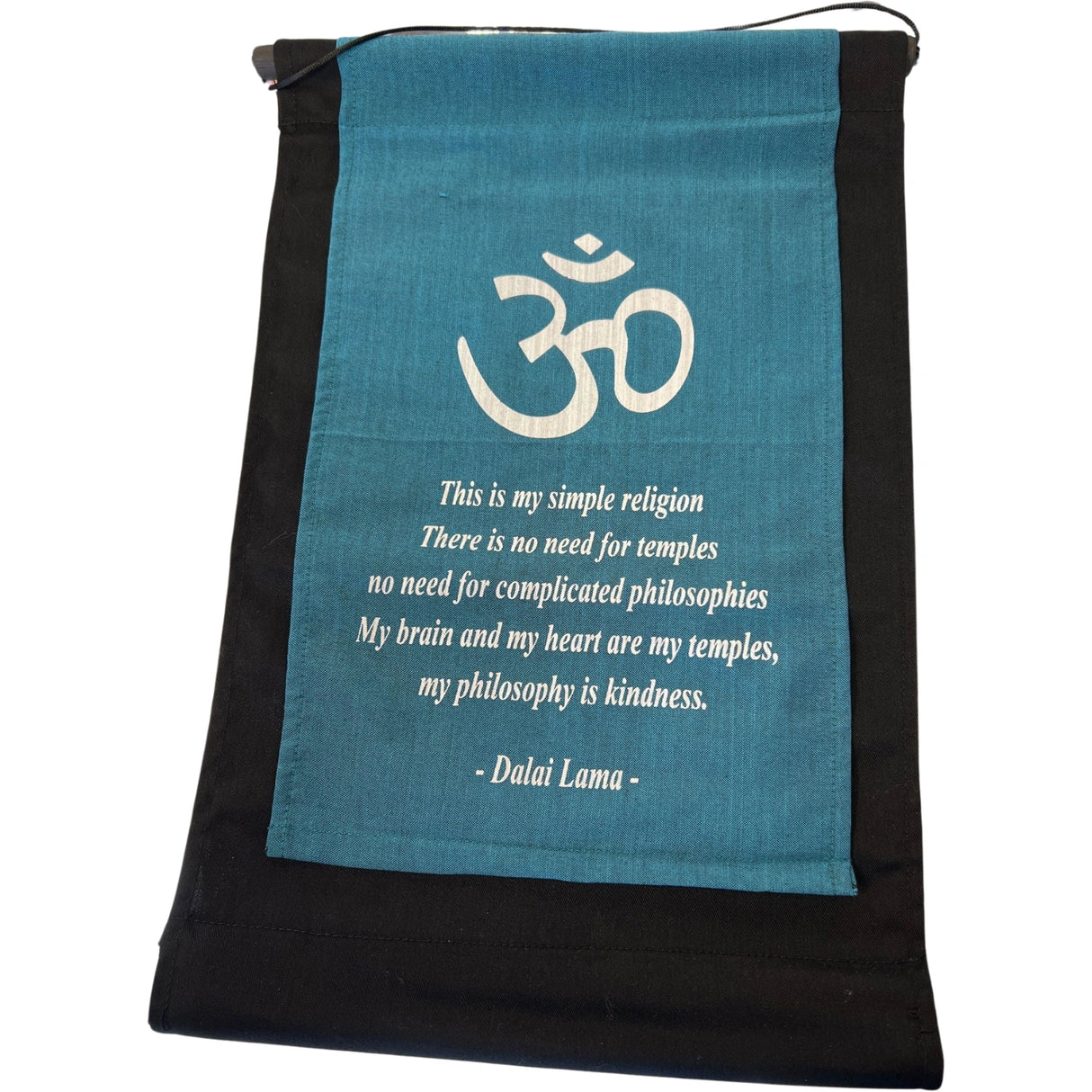 Teal banner with the OM symbol and a quote by the Dalai Lama about religion and kindness.