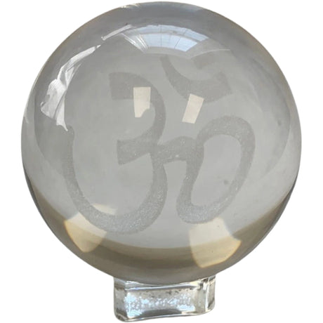 Clear crystal sphere with the OM symbol etched inside.