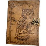 Brown leather journal with owl and tree design and brass lock.