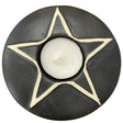 Black ceramic candle holder shaped like a star with a white outline.