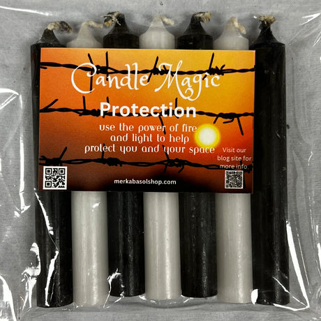 Black and white candles in clear plastic packaging.