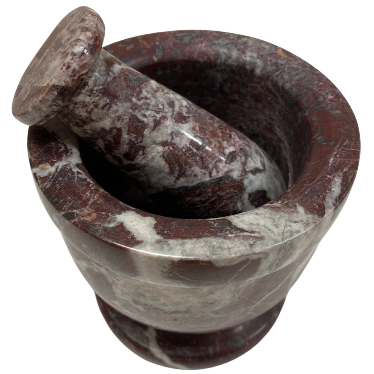 Red marble mortar and pestle set with white veins.