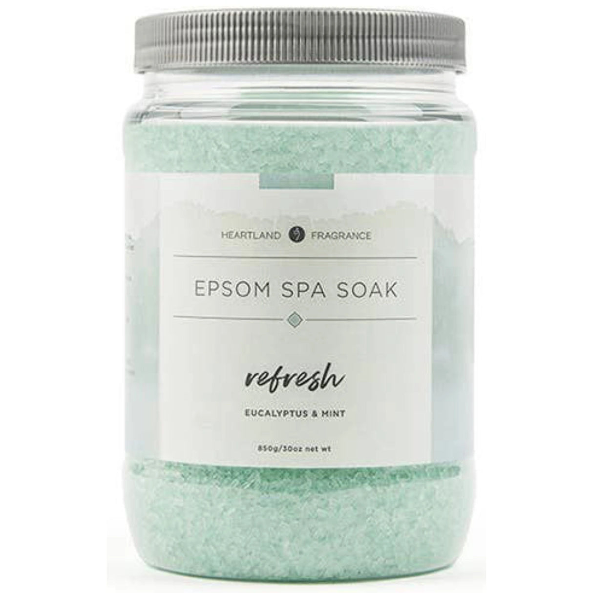 Clear plastic jar filled with green Epsom salt crystals. The label reads "Heartland Fragrance Epsom Spa Soak Refresh Eucalyptus & Mint" and includes the net weight (850g/30oz).