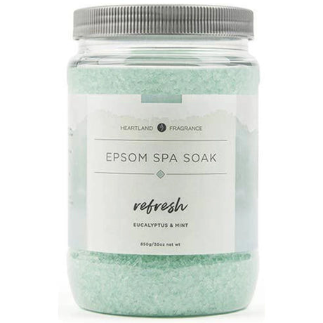 Clear plastic jar filled with green Epsom salt crystals. The label reads "Heartland Fragrance Epsom Spa Soak Refresh Eucalyptus & Mint" and includes the net weight (850g/30oz).