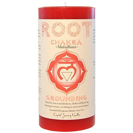 Red pillar candle with the word "ROOT CHAKRA" and the symbol Muladhara printed on it. The candle also features a grounding affirmation and information about essential oils and crystal journey.