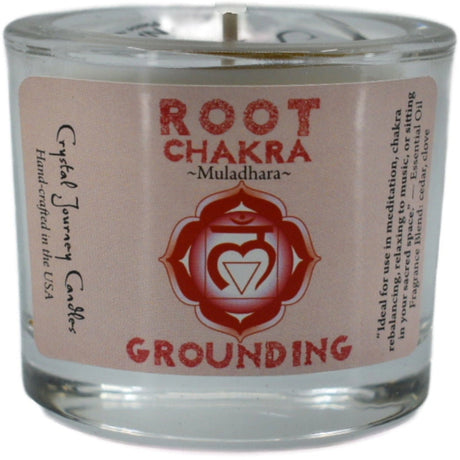 Red votive candle with the words "ROOT CHAKRA," "MULADHARA," and "GROUNDING" printed on it. The candle is surrounded by a white label with additional information about its use for meditation and chakra balancing.