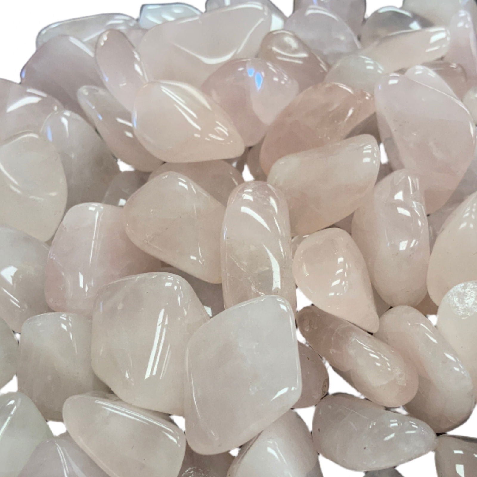 Rose Quartz Tumbled - Close-up of light pink tumbled polish stones rose quartz 