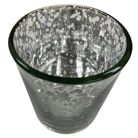 Clear glass votive candle holder with a silver, textured exterior.