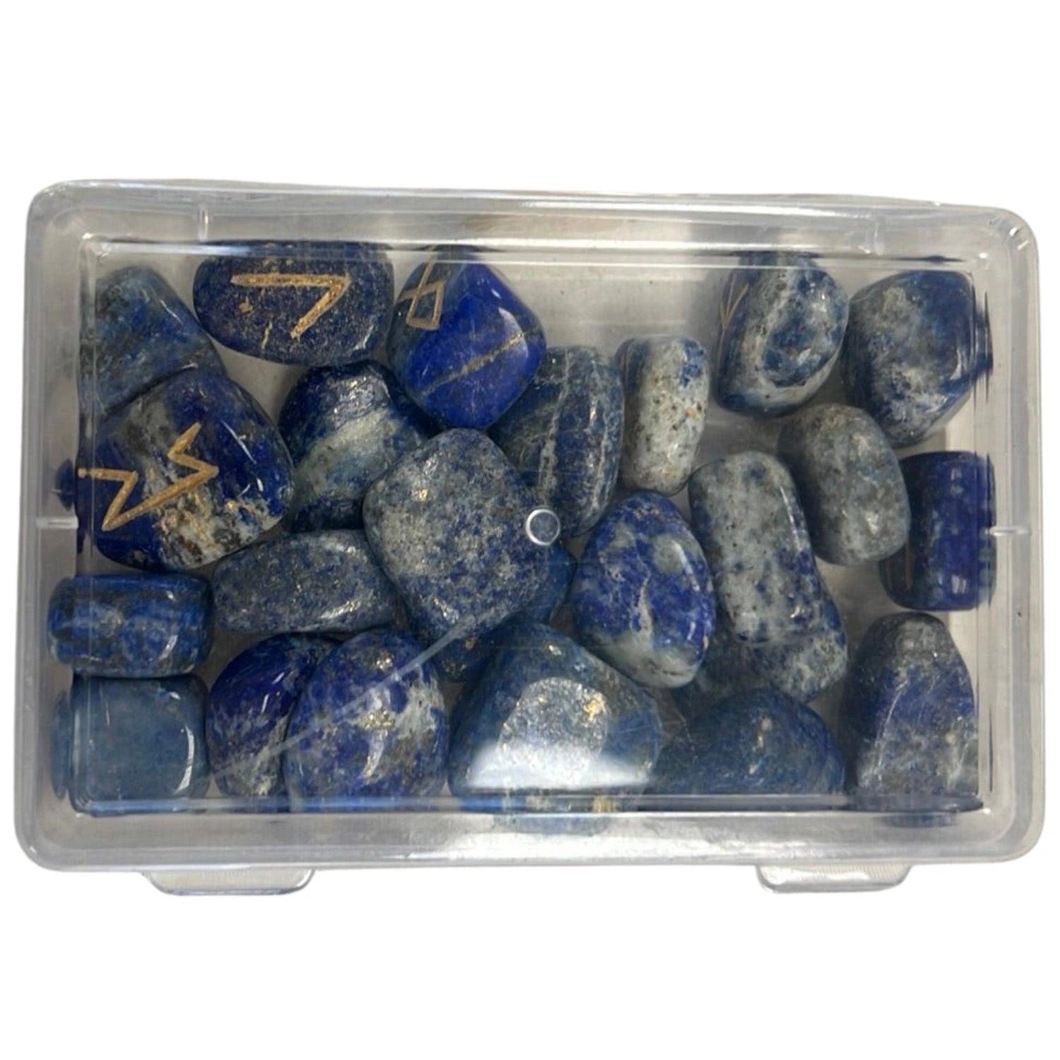 Blue sodalite stones with gold runes engraved on them in a clear plastic box.