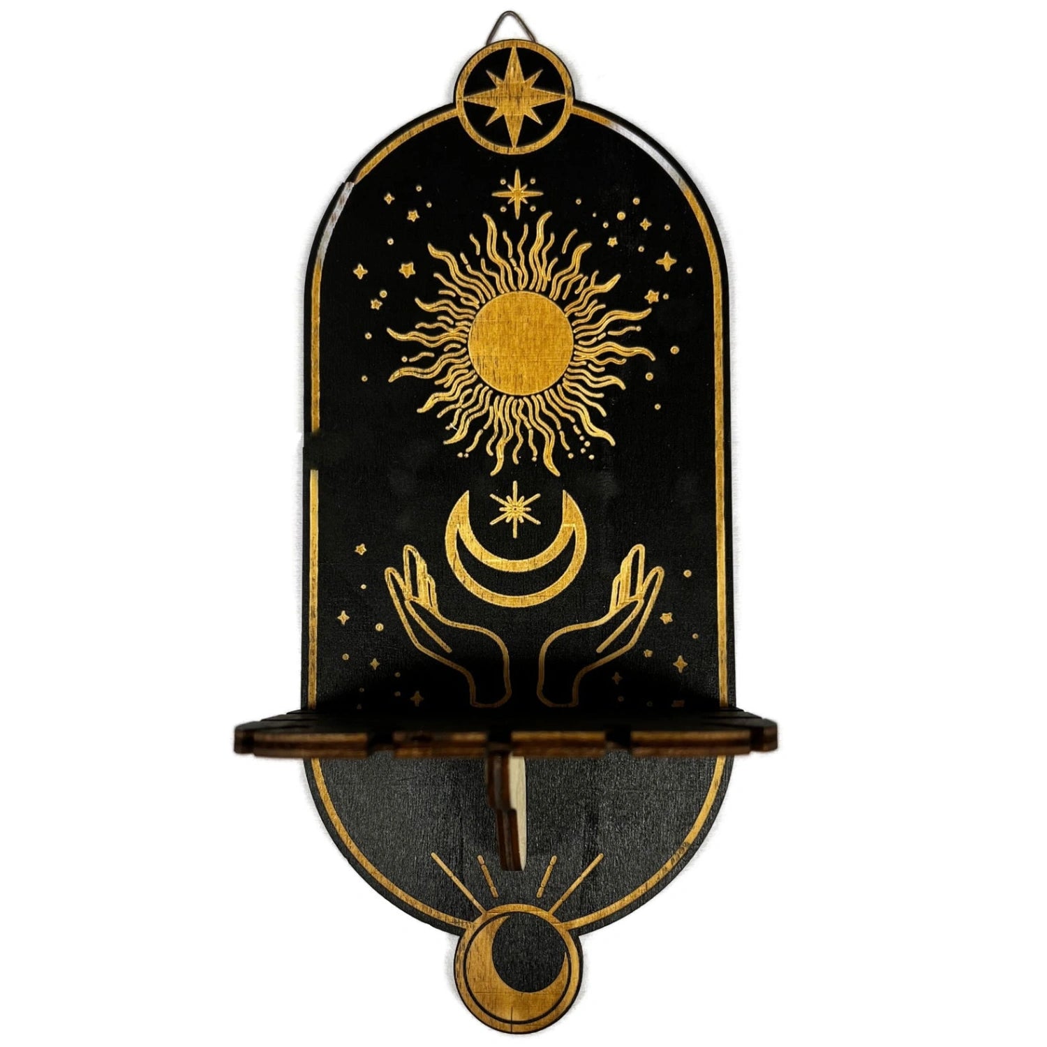 Black wooden shelf with a gold sun and moon design. The shelf has a hanging chain for a pendulum.