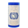 Blue pillar candle with the words "THIRD EYE CHAKRA" and the symbol Ajna printed on it. The candle also features the word "INTUITION" and information about its use for meditation and chakra balancing.