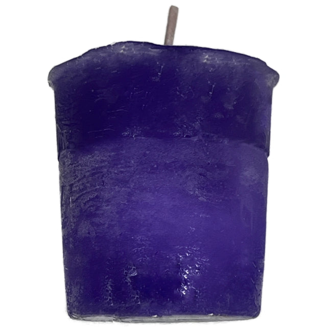 Purple votive candle with a smooth, unadorned surface.