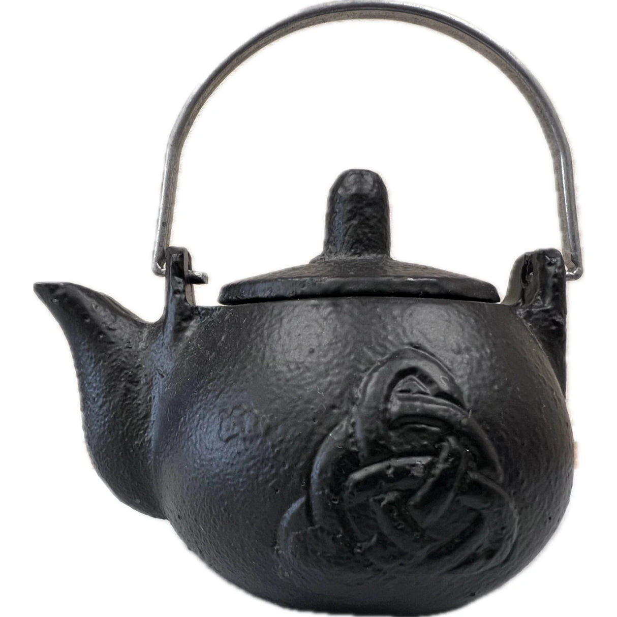 Small black cast iron kettle with a Celtic knot design and a metal handle.