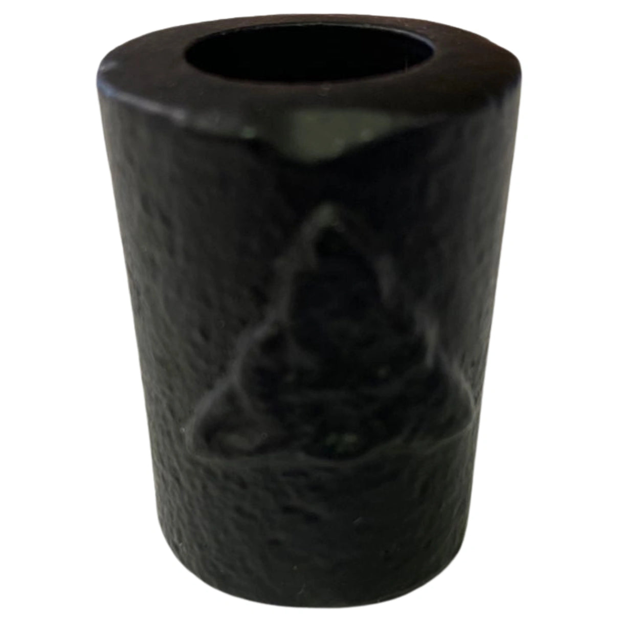 Black cast iron candle holder with a triquetra symbol embossed on it.