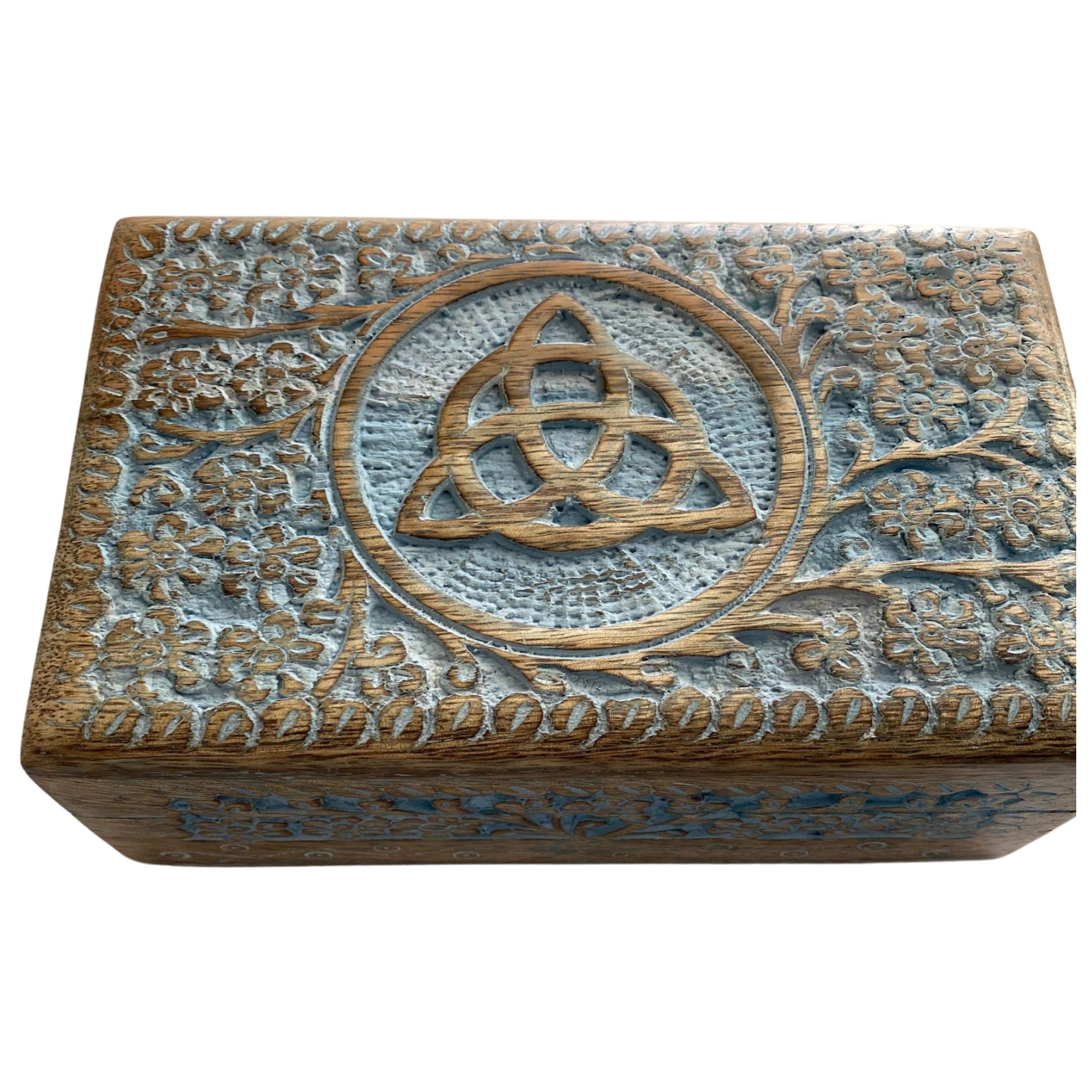 Wooden box with a carved triquetra symbol surrounded by floral designs.