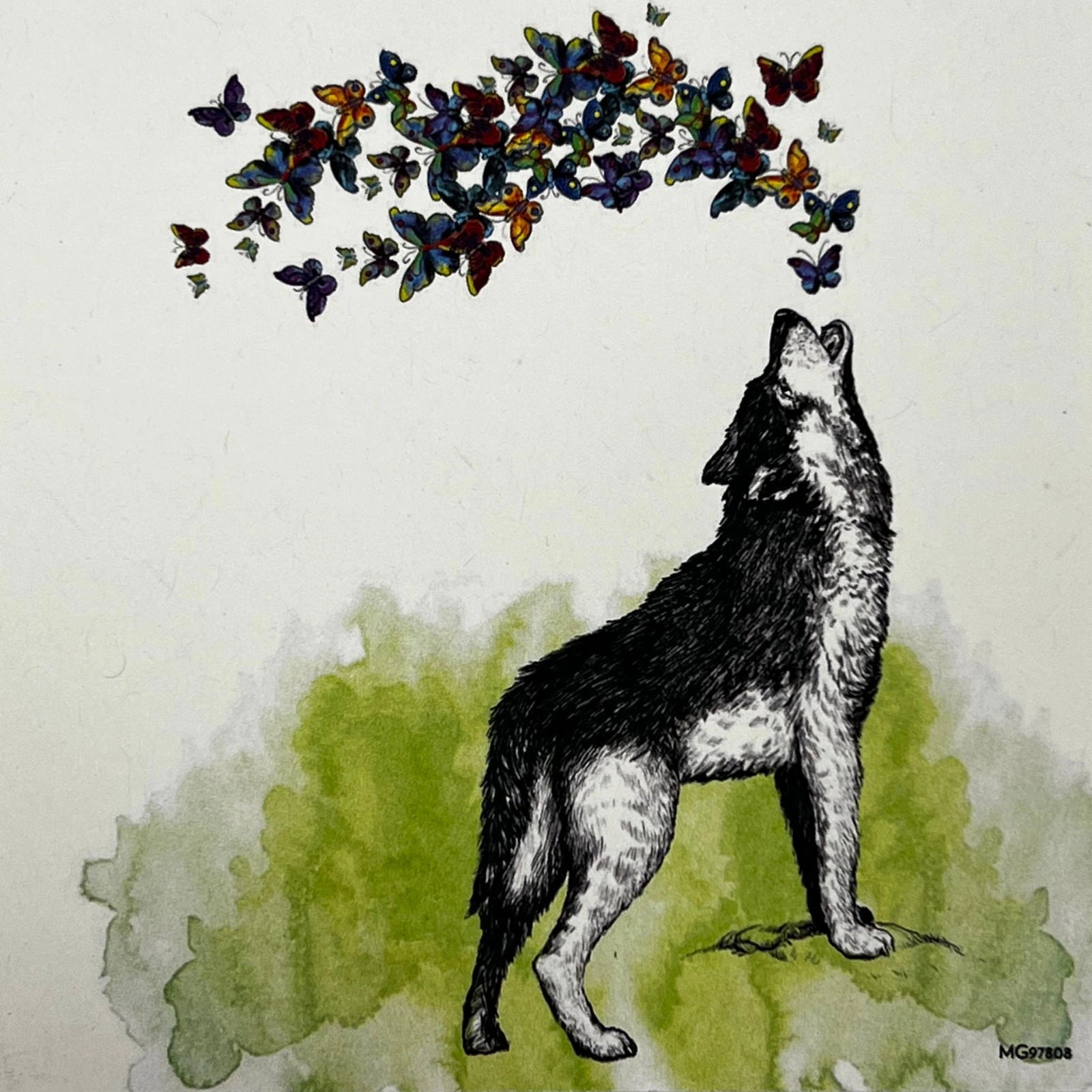 Wolf Butterfly magnet with a wolf howling and butterflies flying around it.