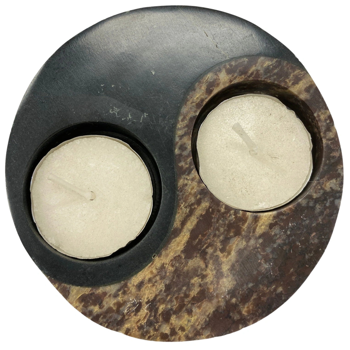 Circular stone candle holder with a yin yang symbol design. The holder has two sections, one black and one brown, each with a small cavity for a tea light.