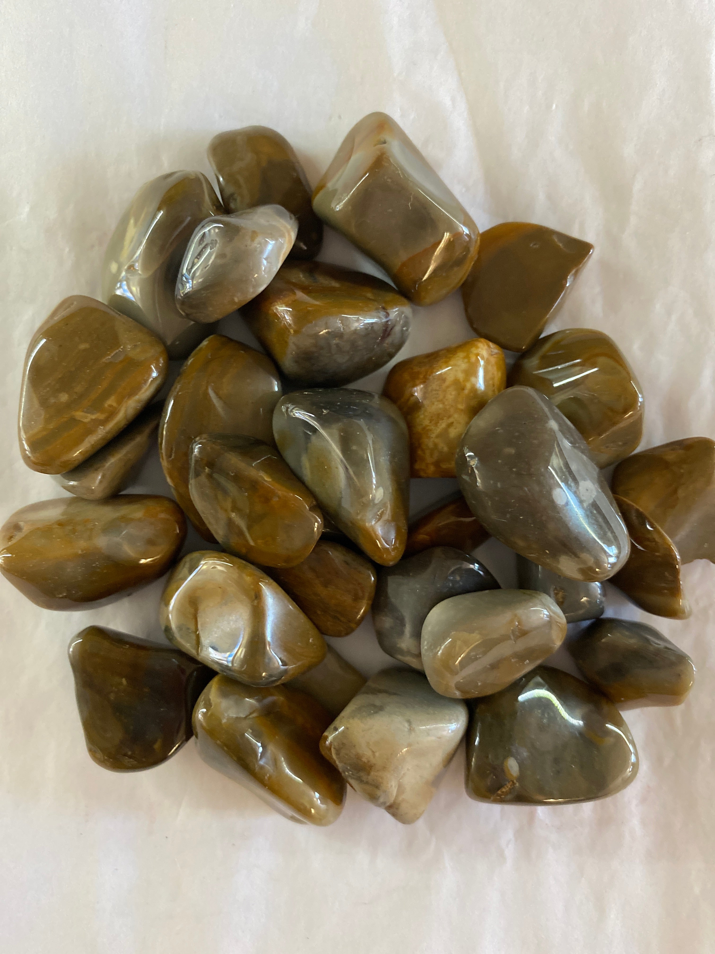 Several polished stone with a unique design, called a Crop Circle Stone, thought to encourage exploration, unconventional thinking, and connection to the cosmos.